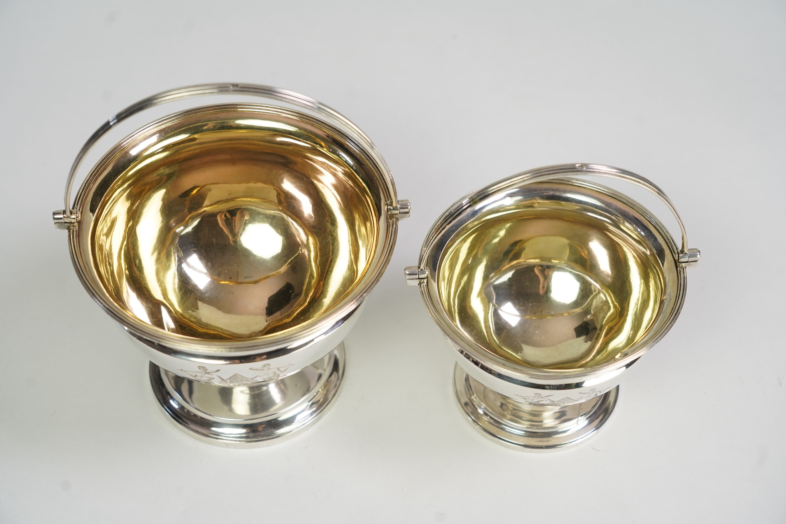Two George III graduated silver pedestal sugar baskets, by James Darquits